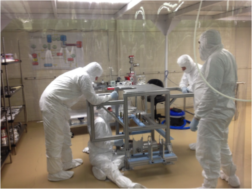 Students and postdocs at UNC assembling the vacuum system for the Majorana Demonstrator Experiment. Majorana will probe the nature of the neutrino and attempt to determine if it is its own antiparticle. The Majorana experiment is being led by the group at UNC.