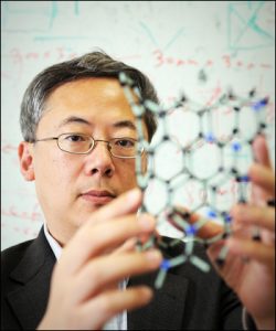 Otto Zhou displays a model of a carbon nanotube (Image courtesy University Gazette.)