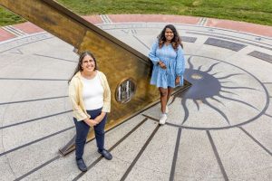 Sheila Kannappan and Mugdha Polimera by the Morehead Planetarium sundial.